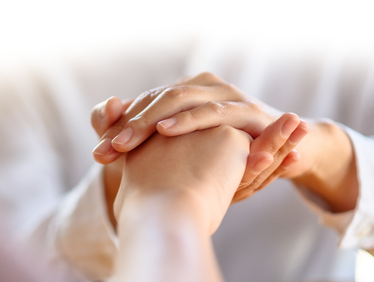 Holding hand compassionately